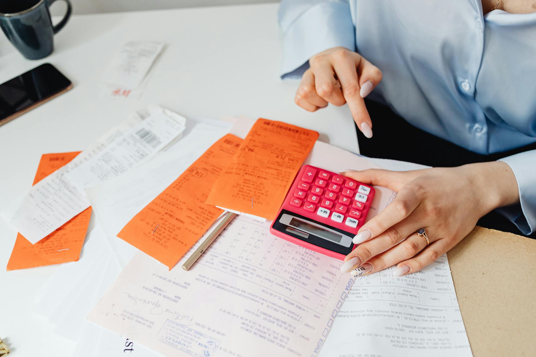 Tax paperwork, receipts, and forms organized on a desk for filing