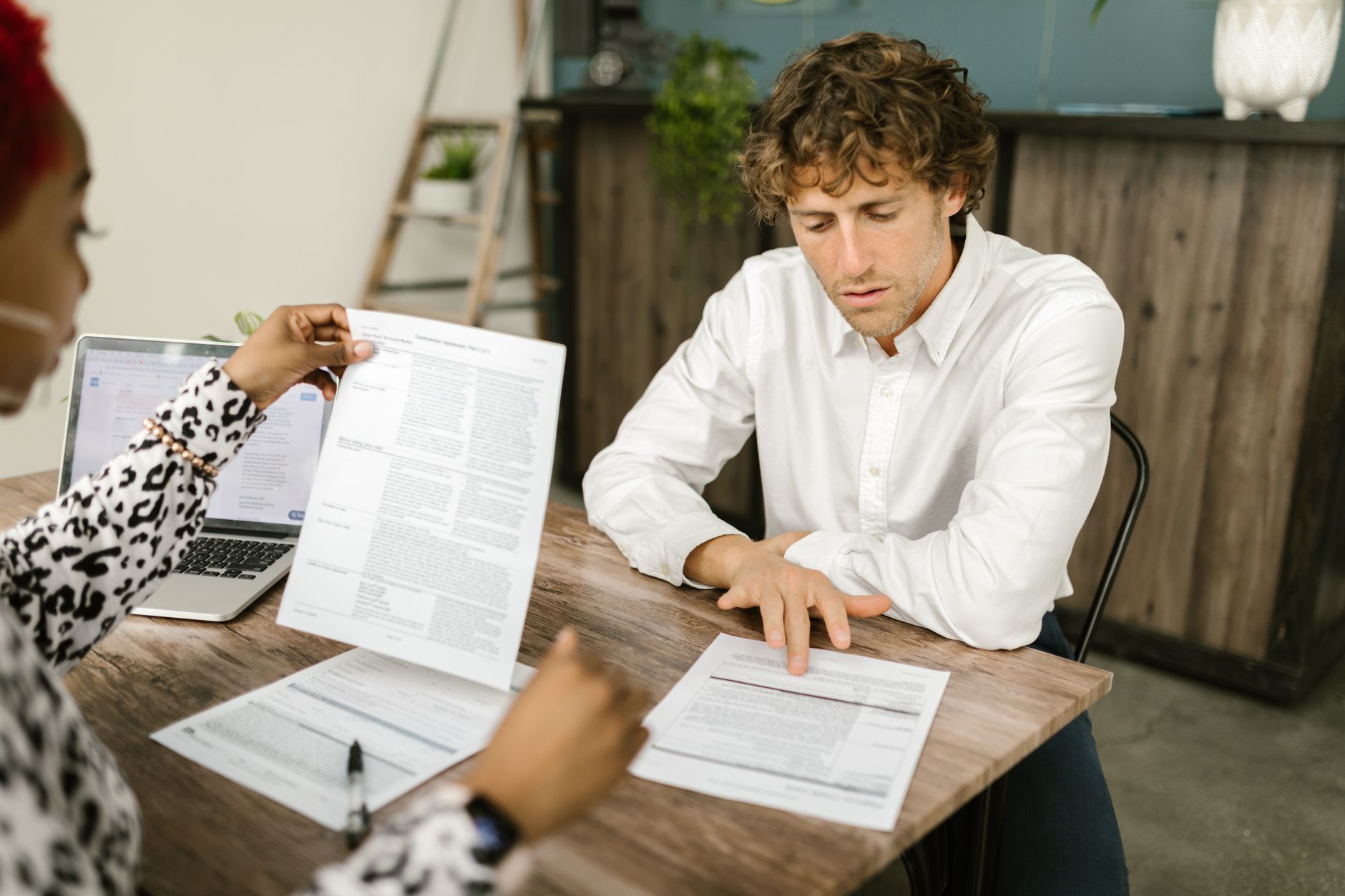 A business owner and accountant reviewing financial statements together at a desk