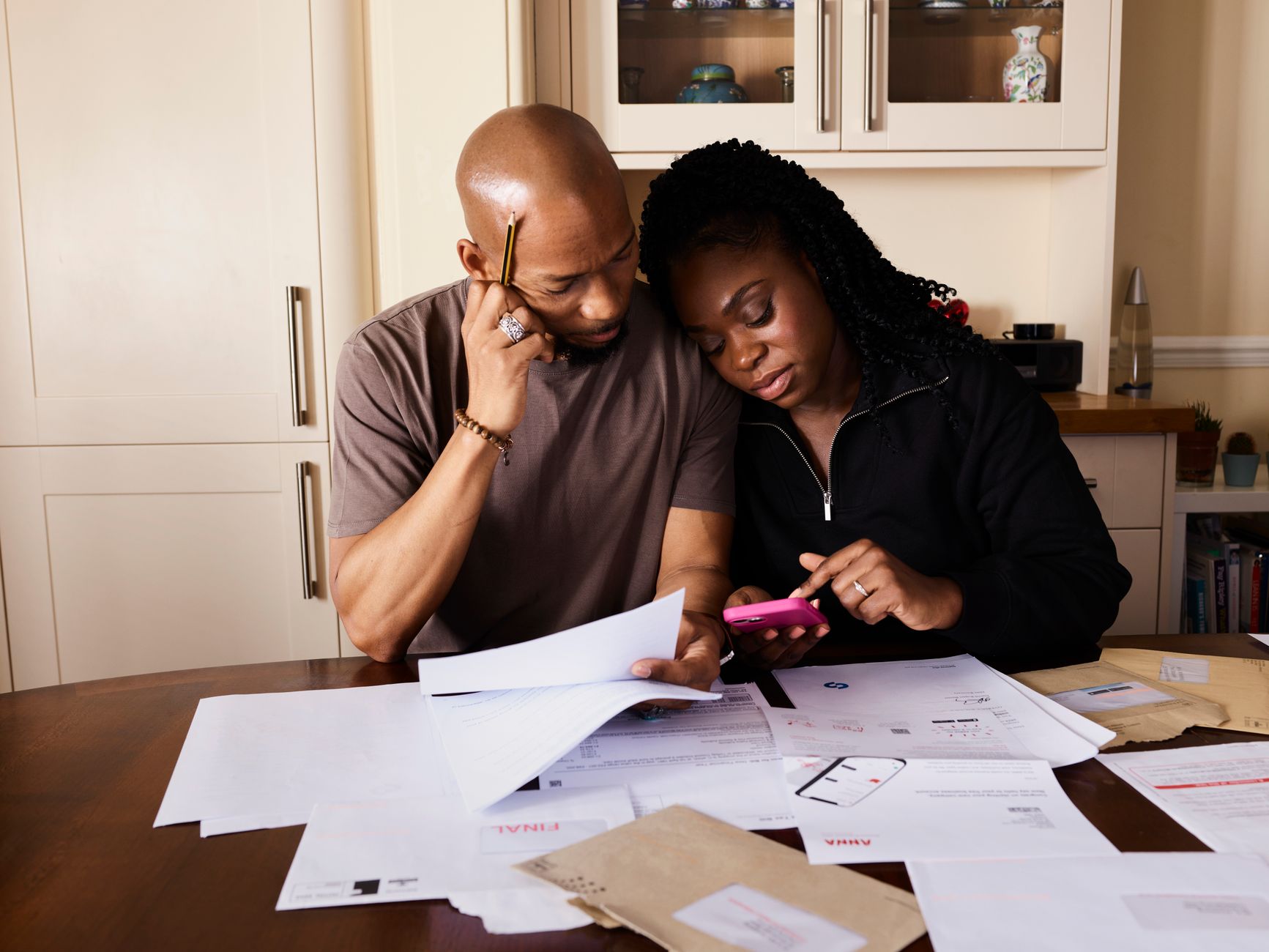 A family reviewing financial and tax documents together at a kitchen table
