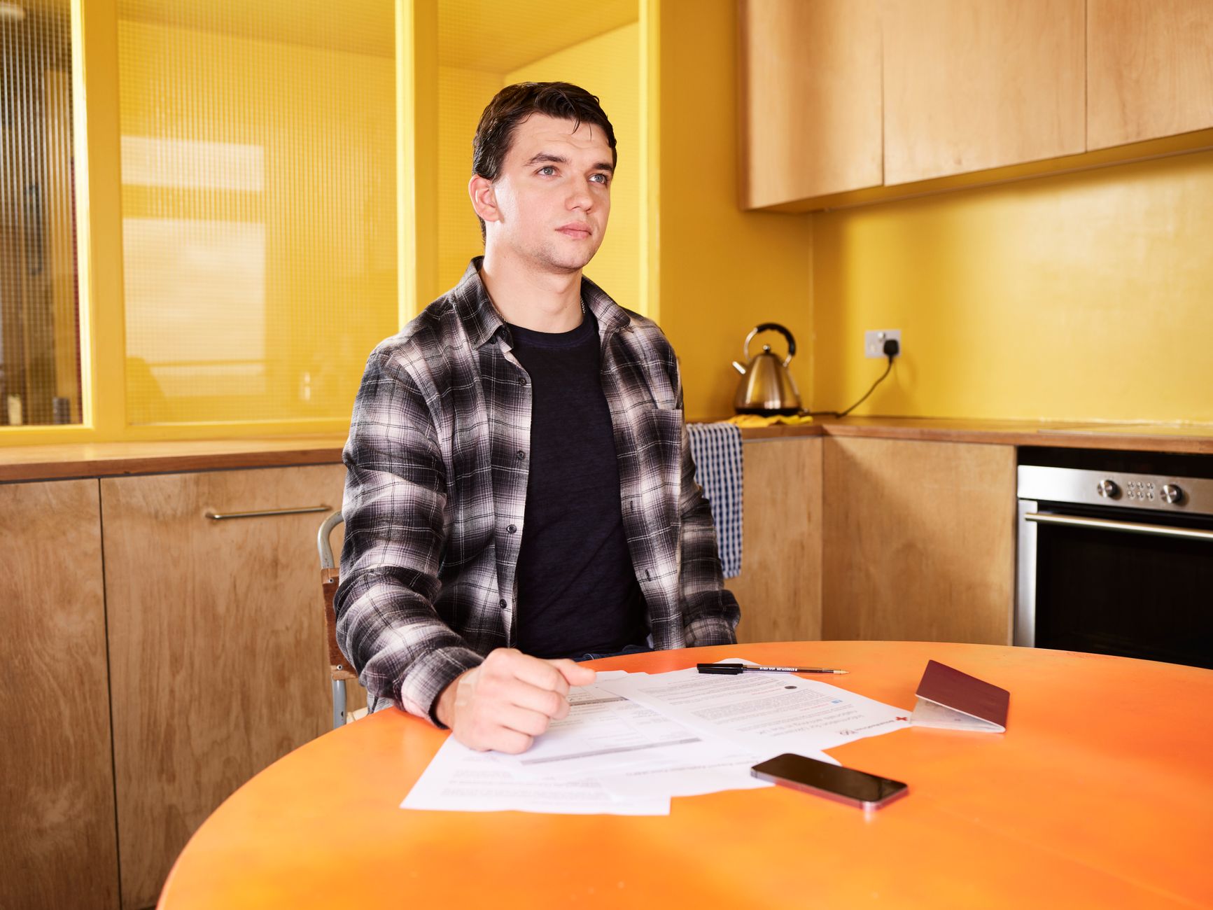 A tipped worker reviewing a pay stub and tax documents at home