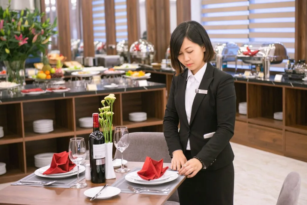 A restaurant server carrying plates during a busy shift