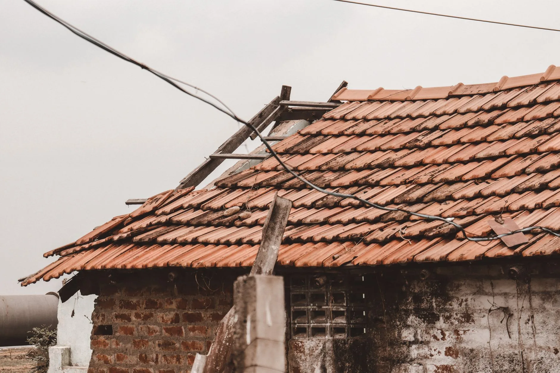 Close-up of damaged roof shingles after a storm